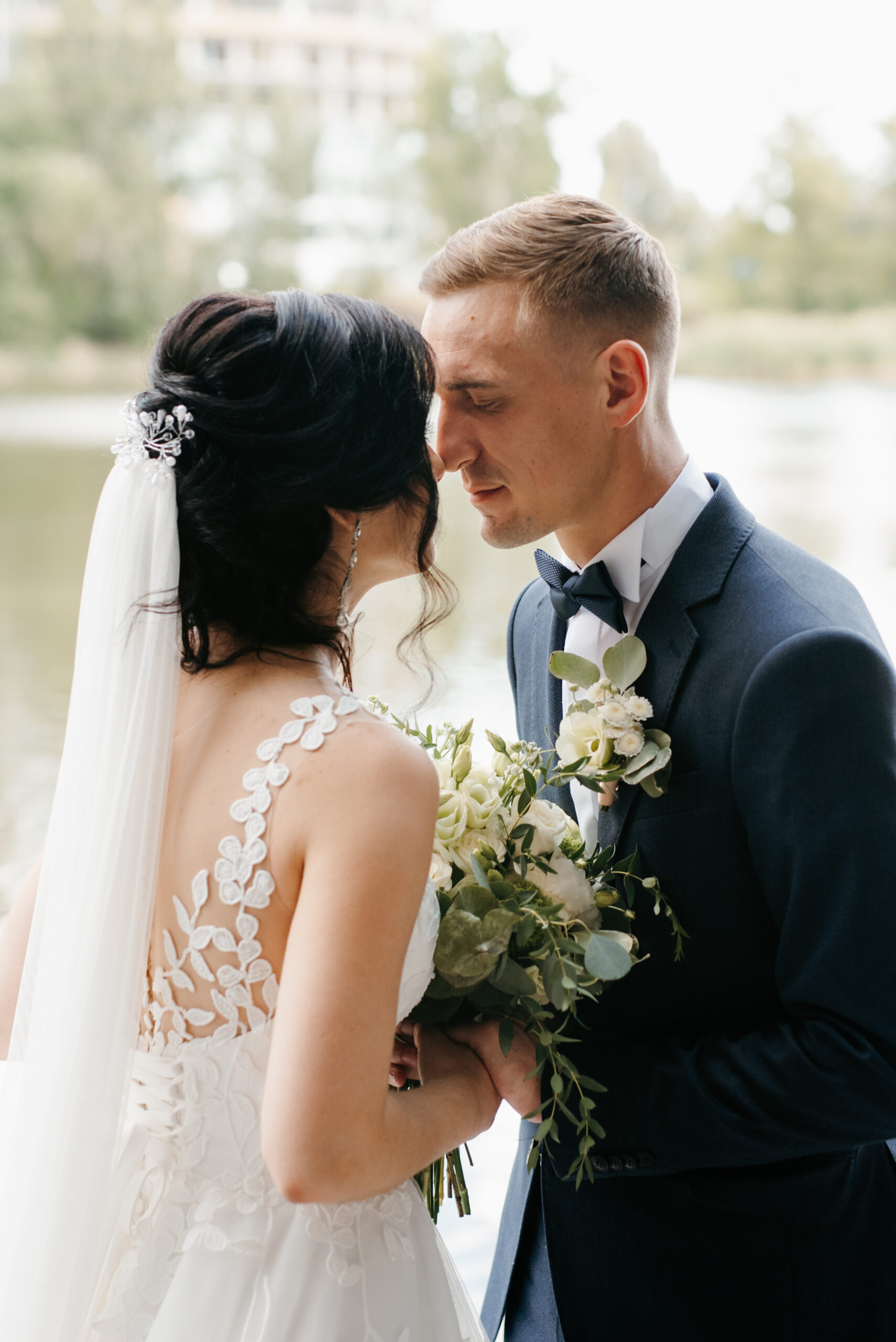 the first meeting of the bride and groom in wedding outfits in the park